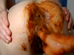 A girl's white butt becomes dark when she spreads poo.